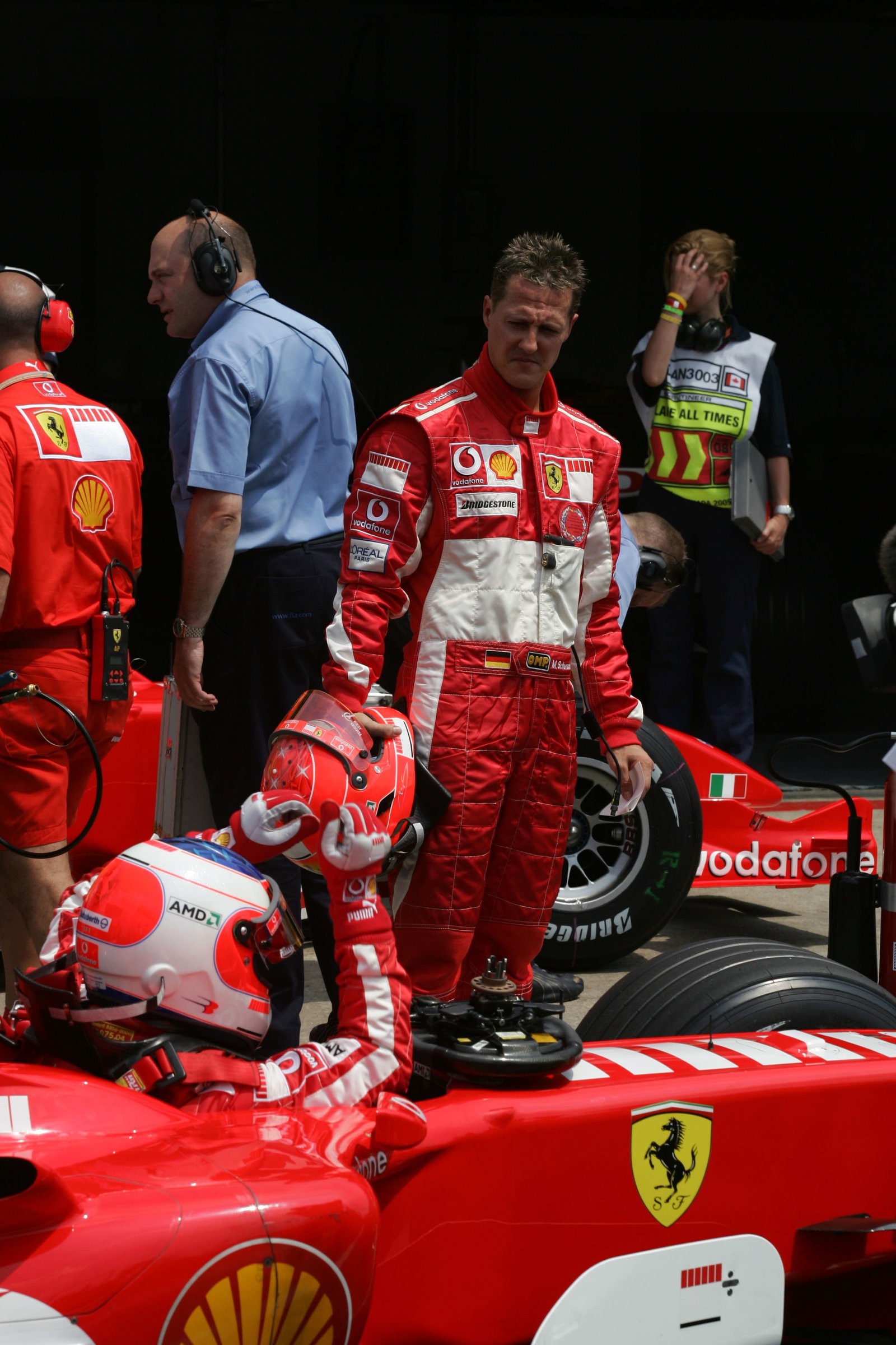 Michael Schumacher waits for Rubens Barrichello after the Brazilian`s qualifying lap was aborted by