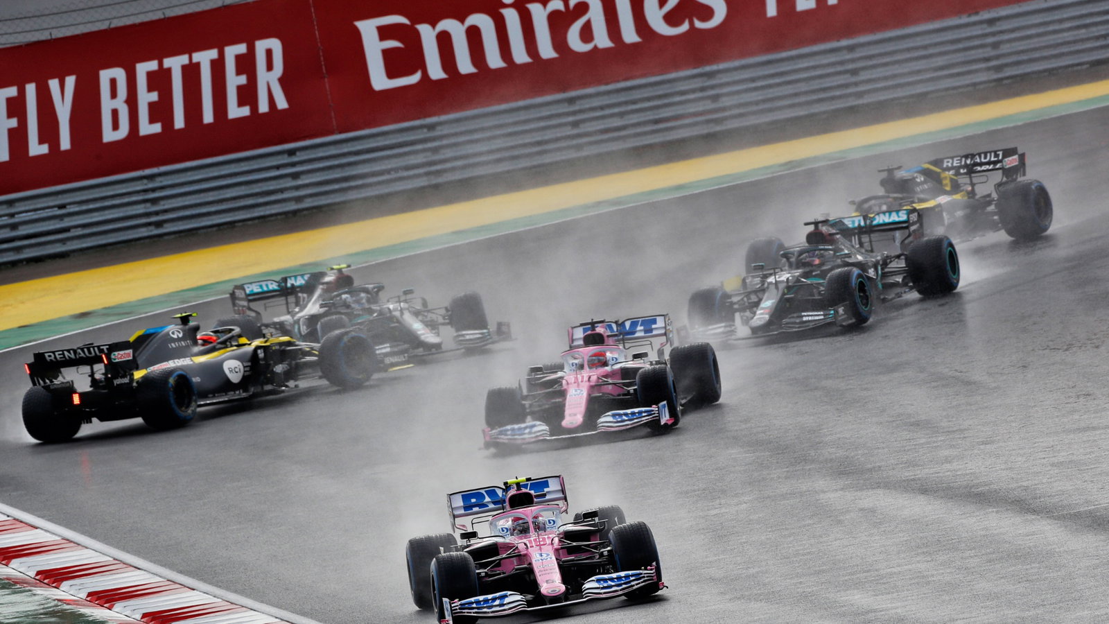 Lance Stroll (CDN) Racing Point F1 Team RP20 leads at the start of the race as Esteban Ocon (FRA) Renault F1 Team RS20 and Valtteri Bottas (FIN) Mercedes AMG F1 W11 spin off the circuit.