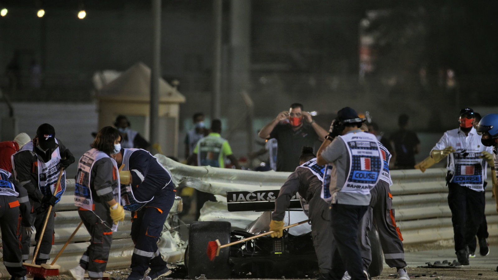 Marshals work on the circuit after Romain Grosjean (FRA) Haas F1 Team VF-20 crashed at the start of the race and exploded into flames.