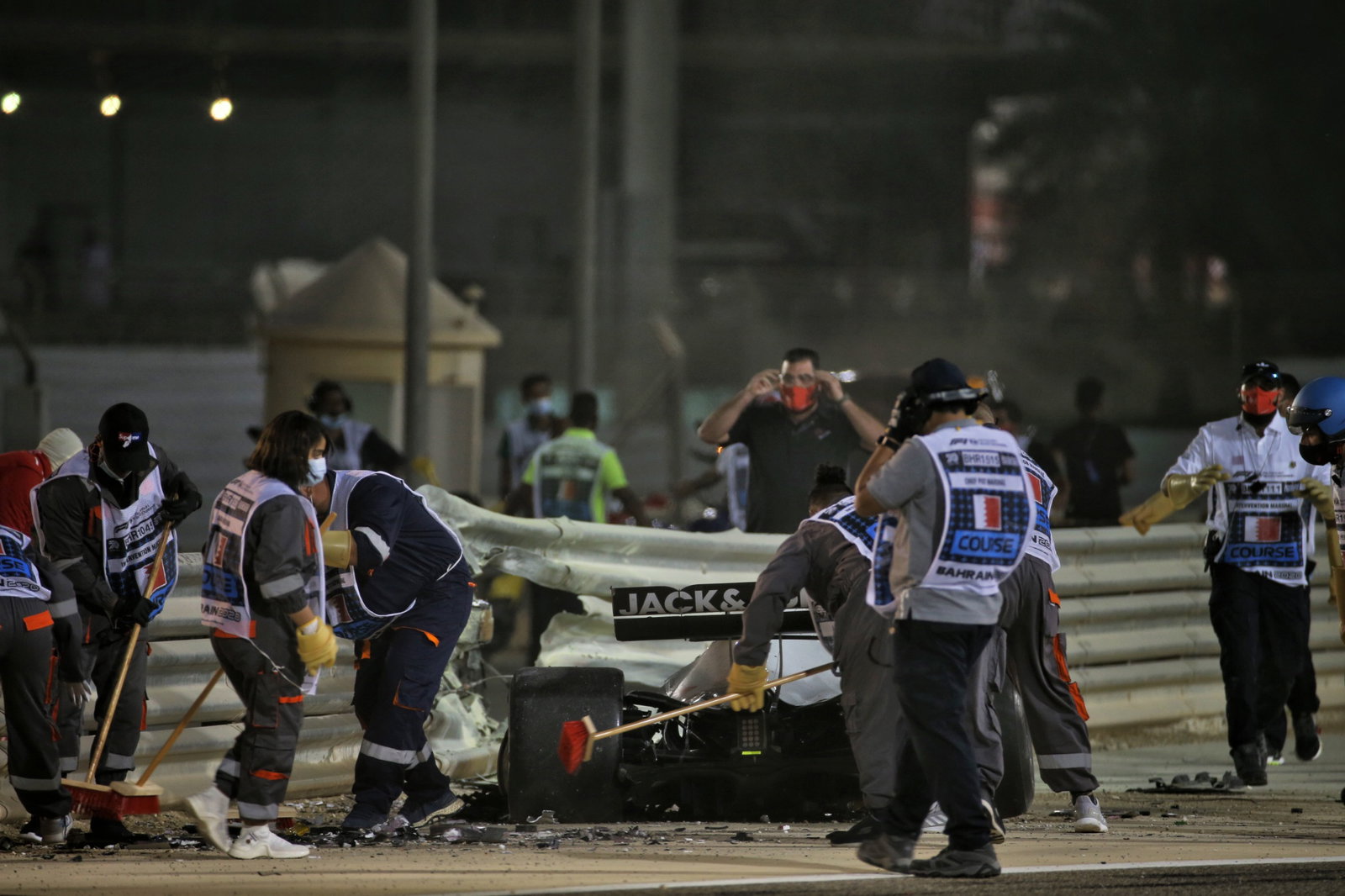 Marshals work on the circuit after Romain Grosjean (FRA) Haas F1 Team VF-20 crashed at the start of the race and exploded into flames.