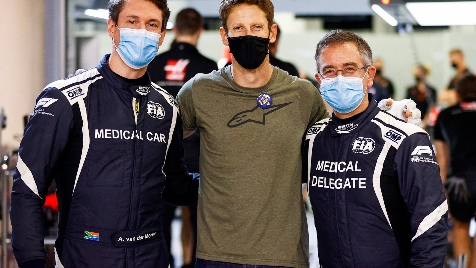 Romain Grosjean (FRA) Haas F1 Team (Centre) with Alan Van Der Merwe (RSA) FIA Medical Car Driver (Left) and Dr Ian Roberts (GBR) FIA Doctor (Right), who assisted in his escape from the fiery crash at the Bahrain Grand Prix.