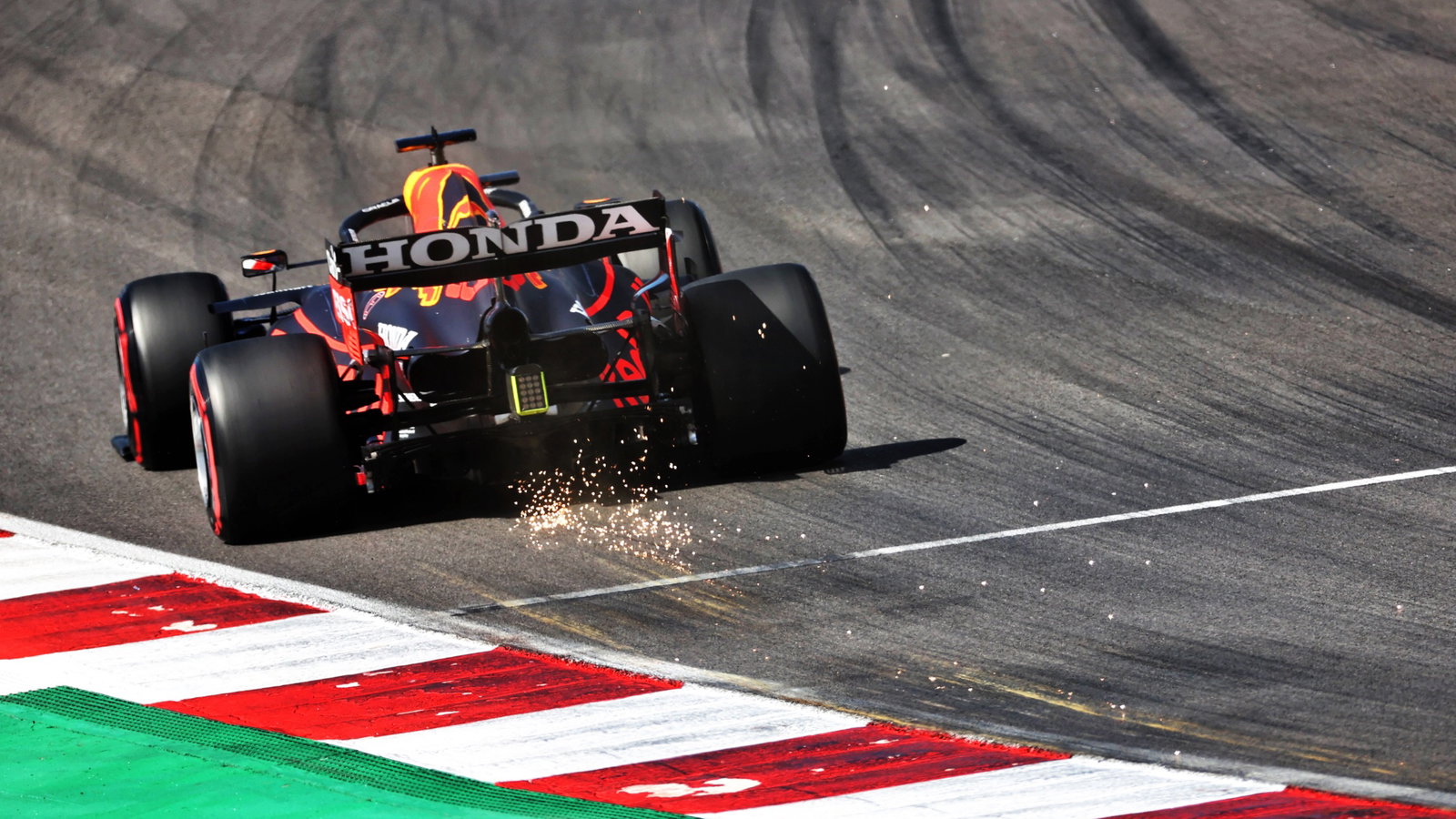 Max Verstappen (NLD) Red Bull Racing RB16B sends sparks flying.