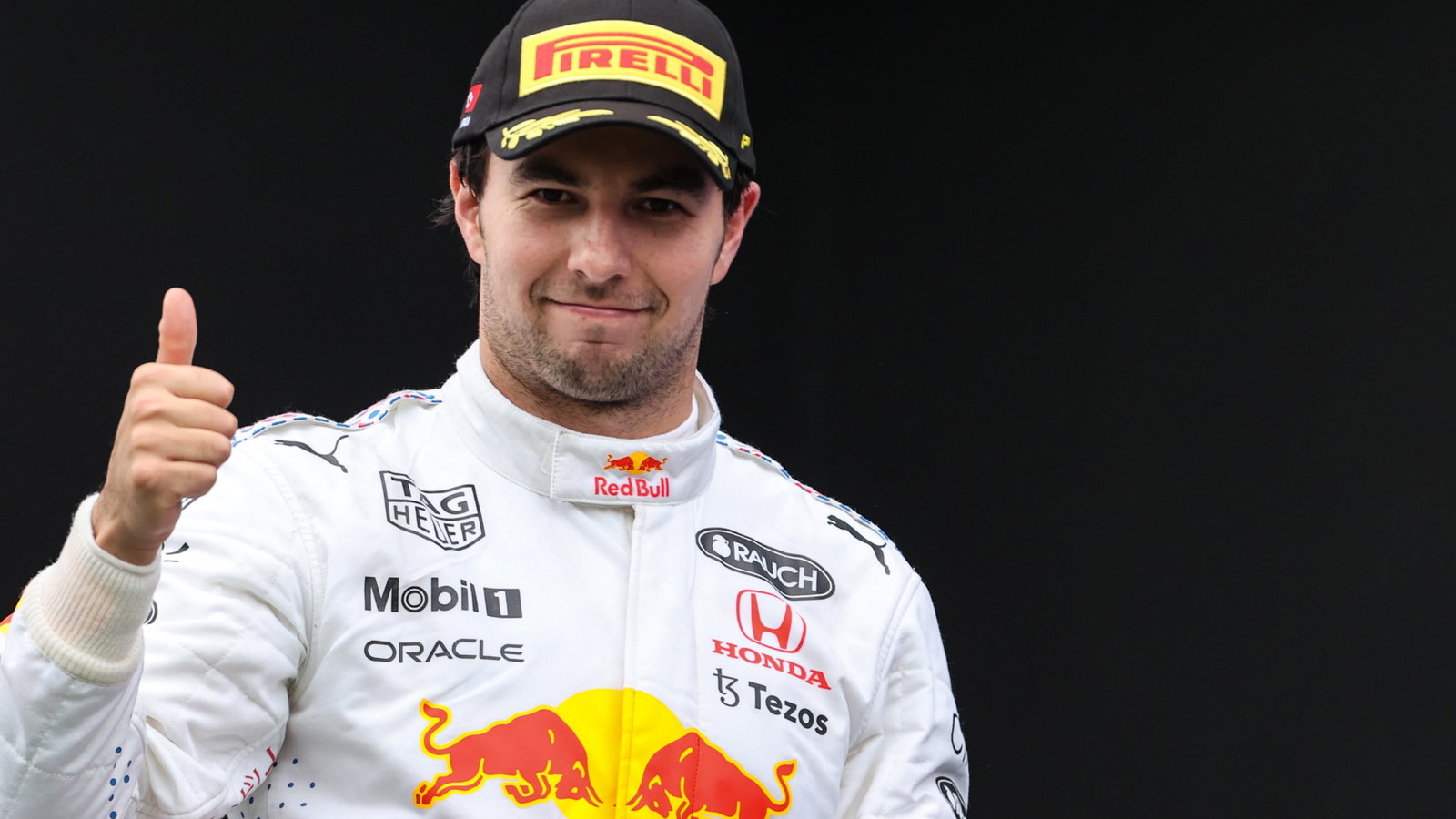 Sergio Perez (MEX) Red Bull Racing celebrates his third position on the podium.