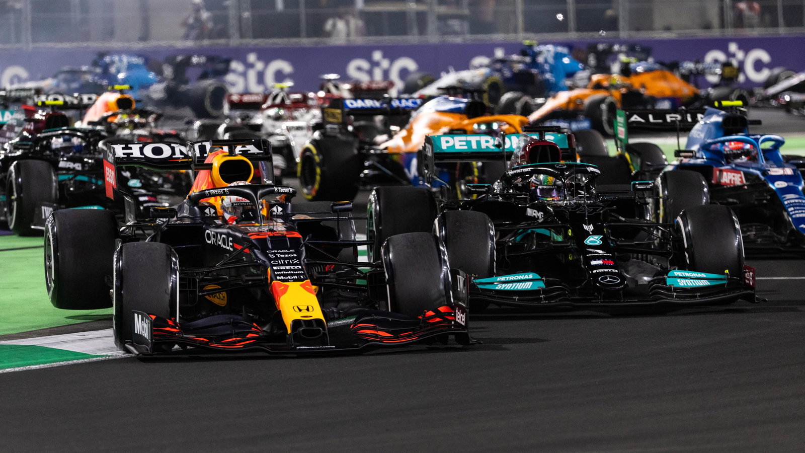 Lewis Hamilton (GBR) Mercedes AMG F1 W12 and Max Verstappen (NLD) Red Bull Racing RB16B battle for the lead at the first race restart.