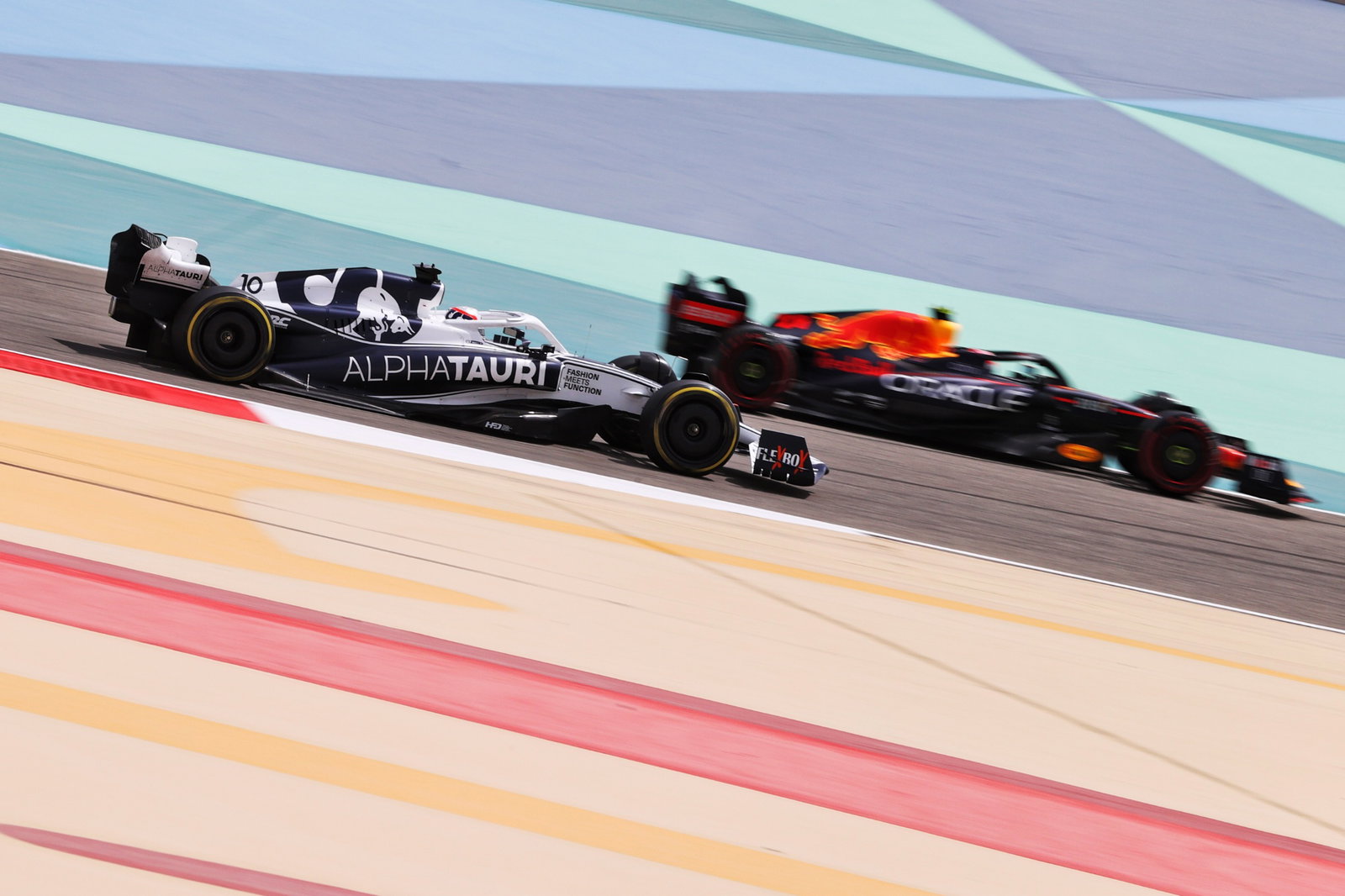 Pierre Gasly (FRA) AlphaTauri AT03 and Sergio Perez (MEX) Red Bull Racing
