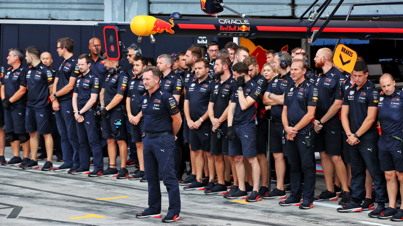 Christian Horner (GBR) Red Bull Racing Team Principal and the Red Bull Racing team in the pits as a minutes's silence is