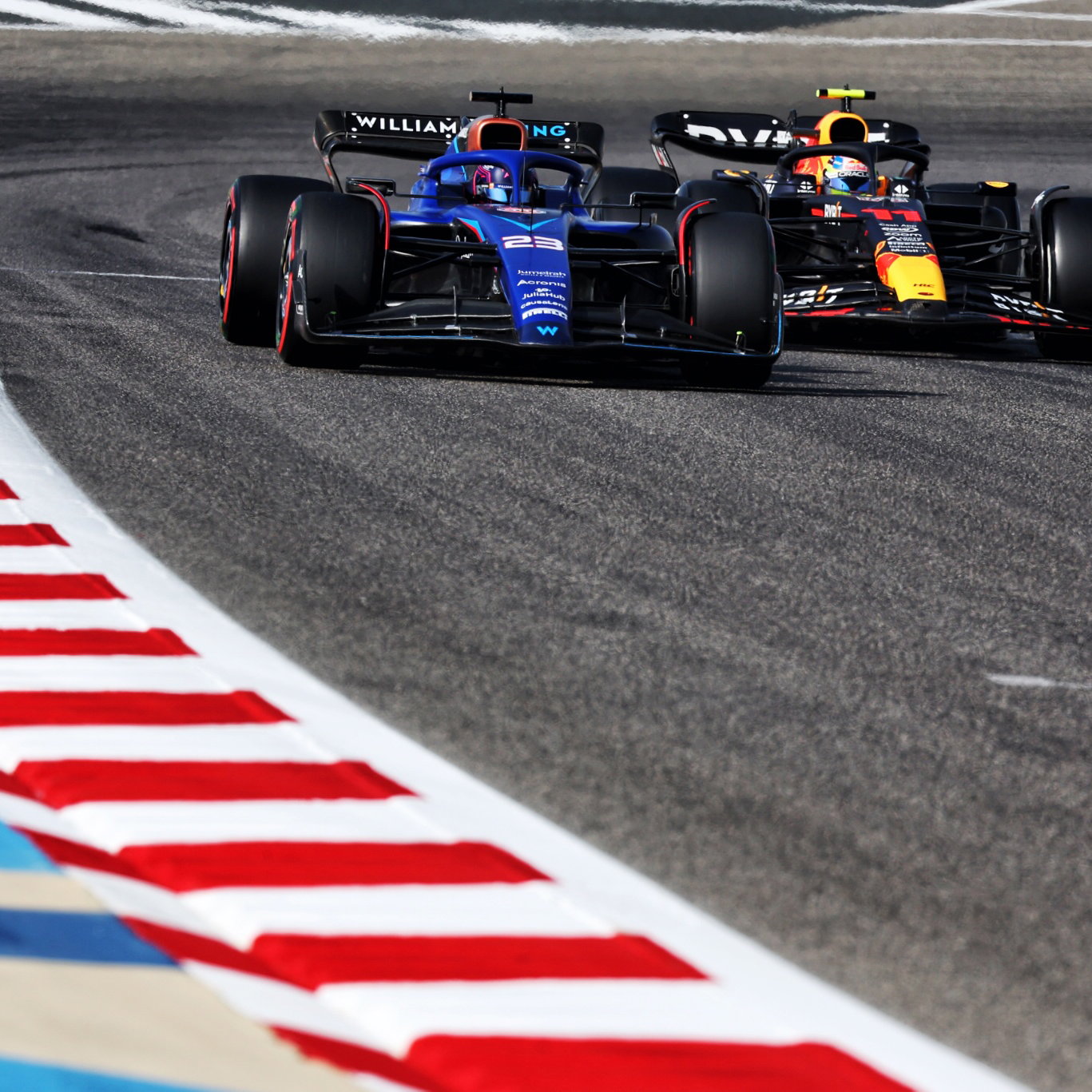 Alexander Albon (THA) Williams Racing FW45 and Sergio Perez (MEX) Red Bull Racing RB19. Formula 1 World Championship, Rd