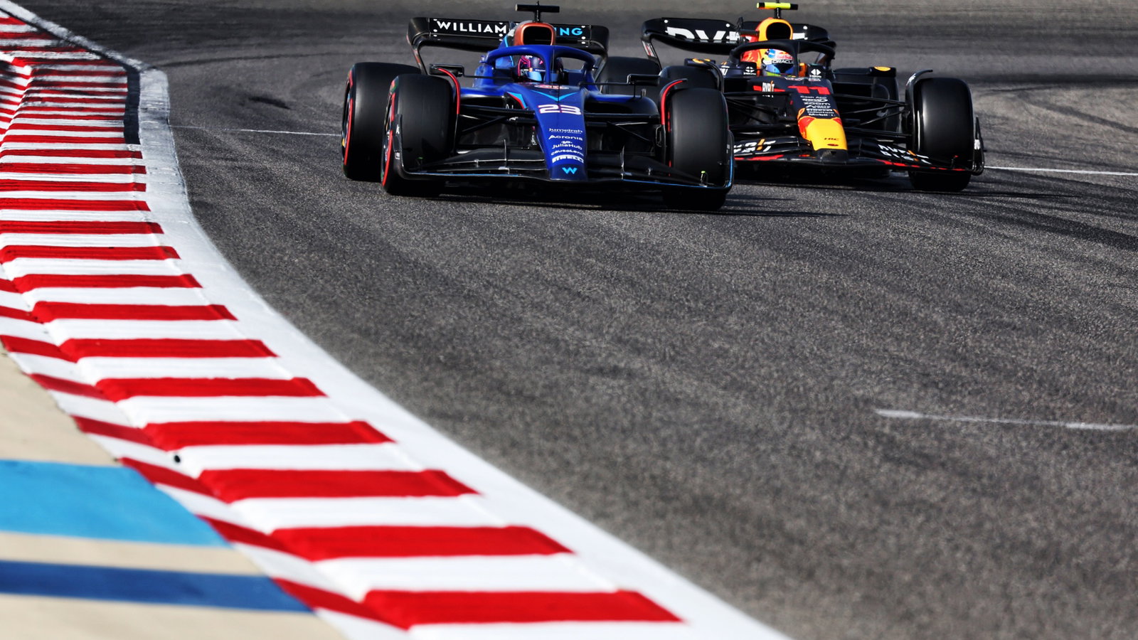 Alexander Albon (THA) Williams Racing FW45 and Sergio Perez (MEX) Red Bull Racing RB19. Formula 1 World Championship, Rd