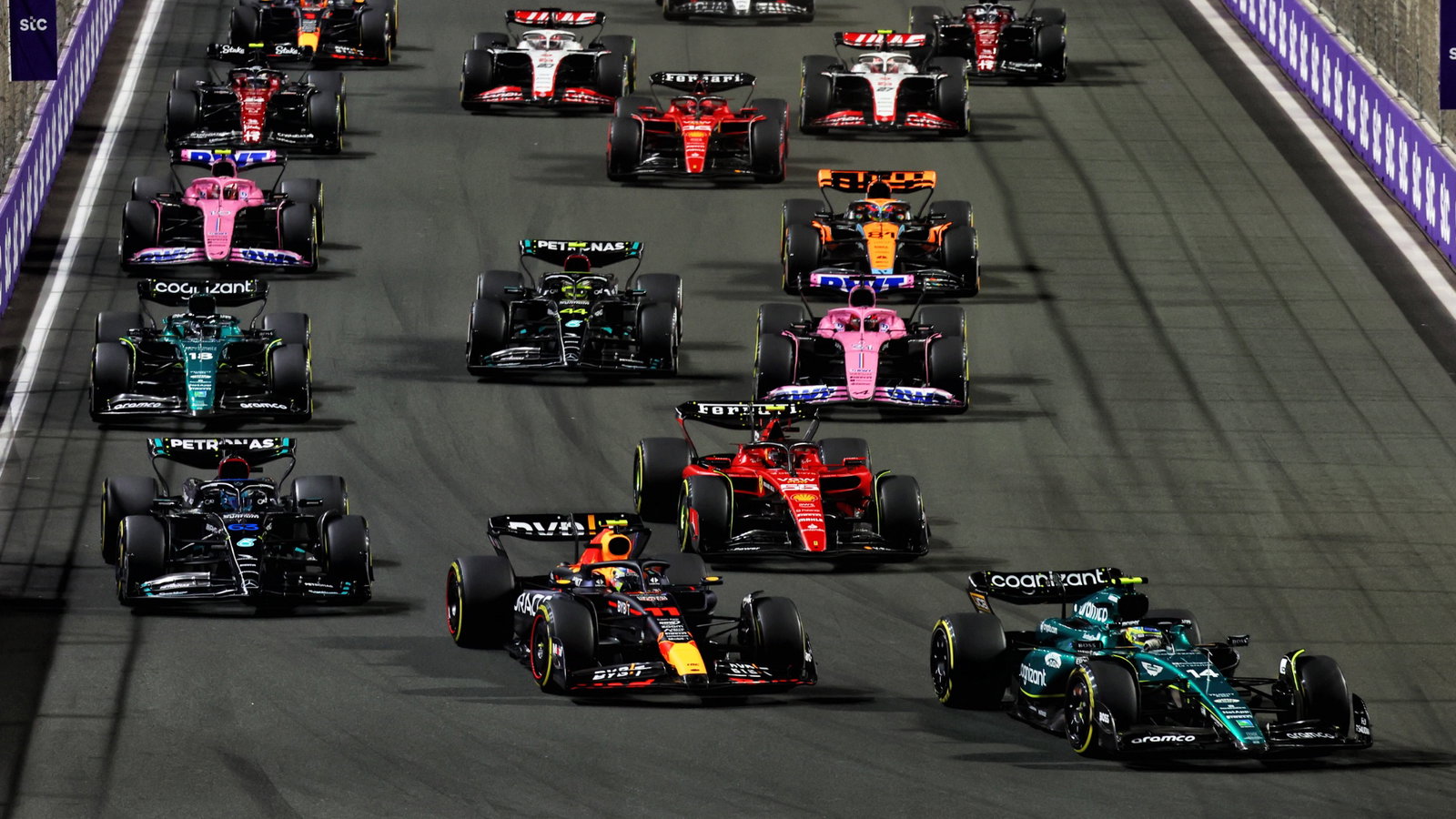 Fernando Alonso (ESP) Aston Martin F1 Team AMR23 leads Sergio Perez (MEX) Red Bull Racing RB19 at the start of the race.
