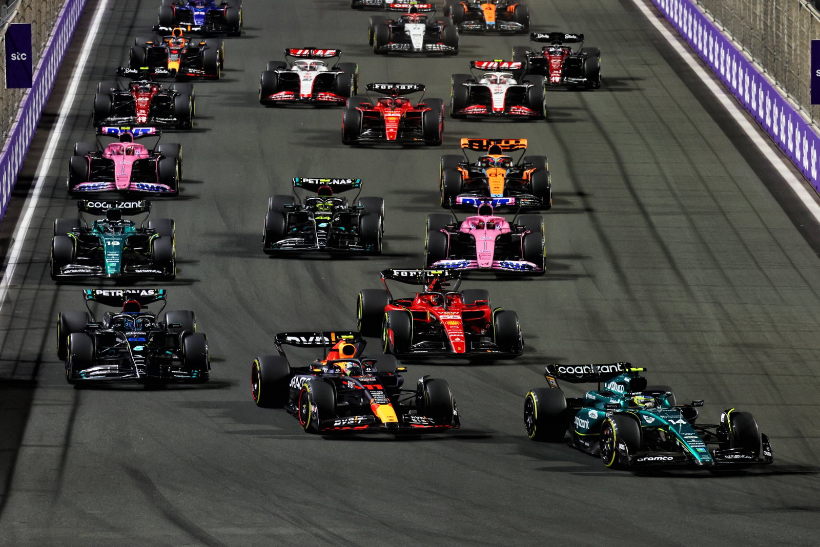 Fernando Alonso (ESP) Aston Martin F1 Team AMR23 leads Sergio Perez (MEX) Red Bull Racing RB19 at the start of the race.
