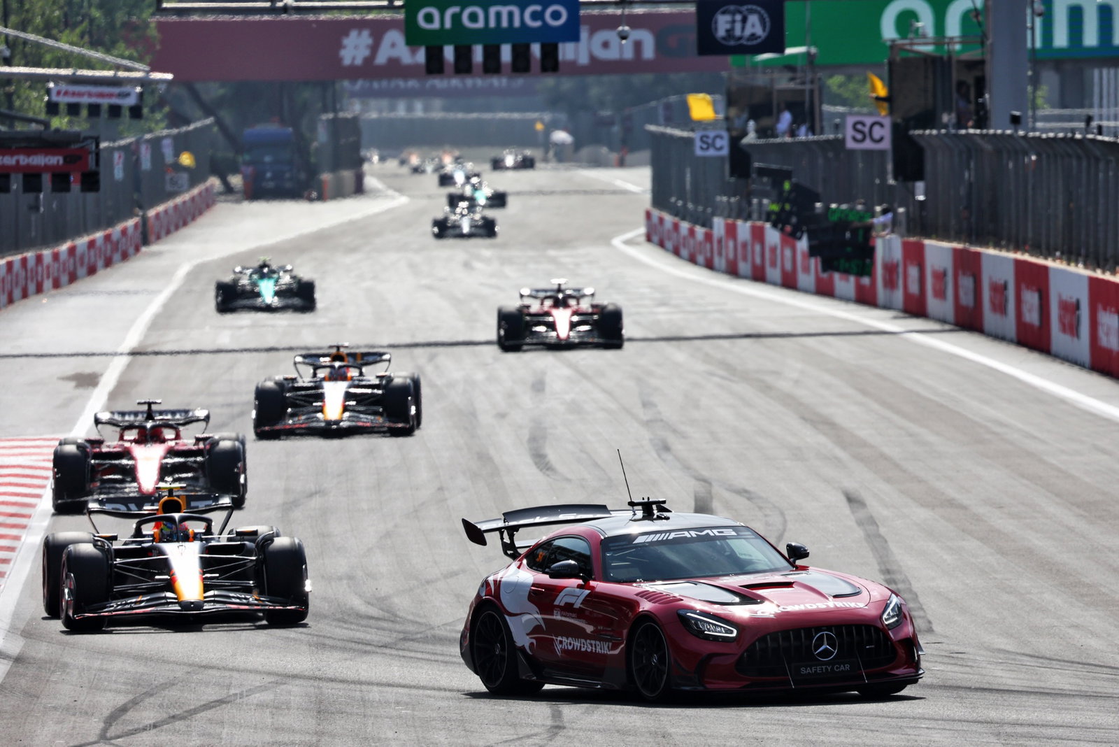 Sergio Perez (MEX) Red Bull Racing RB19 leads behind the Mercedes FIA Safety Car. Formula 1 World Championship, Rd 4,