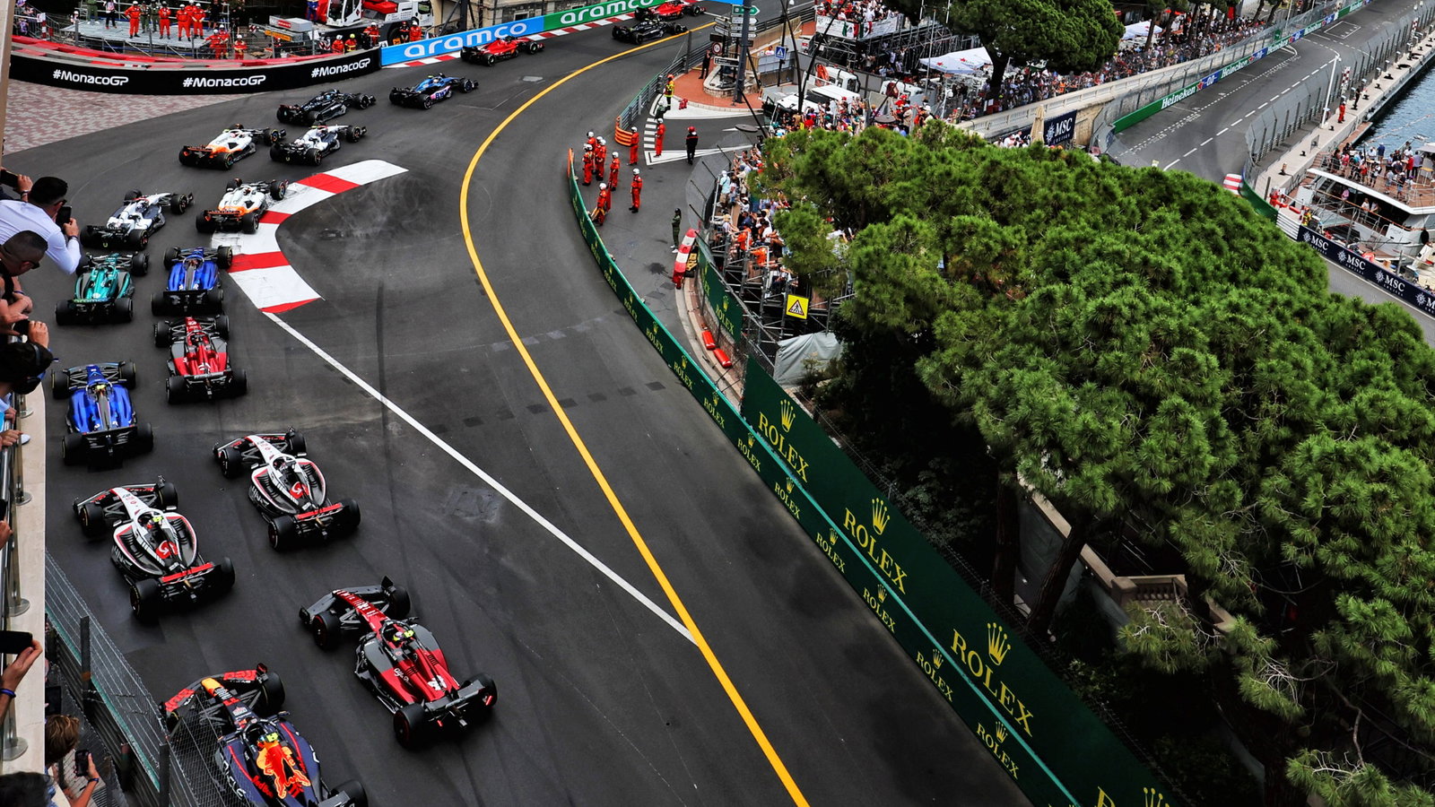 Sergio Perez (MEX) Red Bull Racing RB19 and Zhou Guanyu (CHN) Alfa Romeo F1 Team C43 at the start of the race. Formula 1