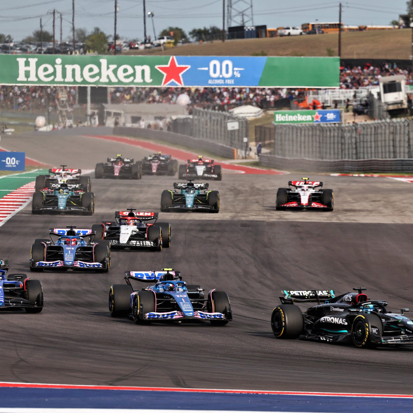 George Russell (GBR) Mercedes AMG F1 W14 leads Pierre Gasly (FRA) Alpine F1 Team A523 and Alexander Albon (THA) Williams