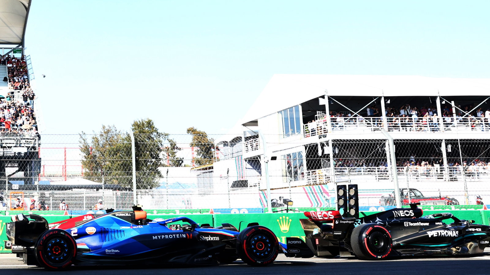 George Russell (GBR) Mercedes AMG F1 W14 stationary at the end of the pit lane with Logan Sargeant (USA) Williams Racing