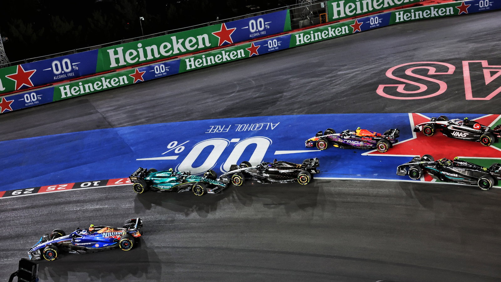 Fernando Alonso (ESP) Aston Martin F1 Team AMR23 spins ahead of Valtteri Bottas (FIN) Alfa Romeo F1 Team C43 at the start of