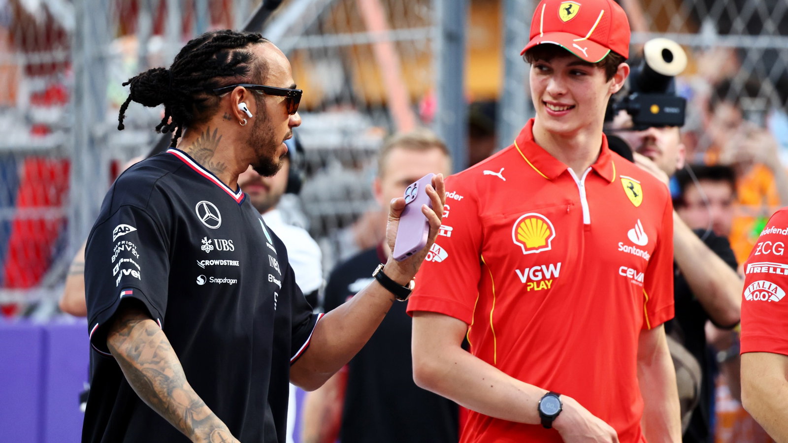 (L to R): Lewis Hamilton (GBR) Mercedes AMG F1 and Oliver Bearman (GBR) Ferrari Reserve Driver on the drivers' parade.