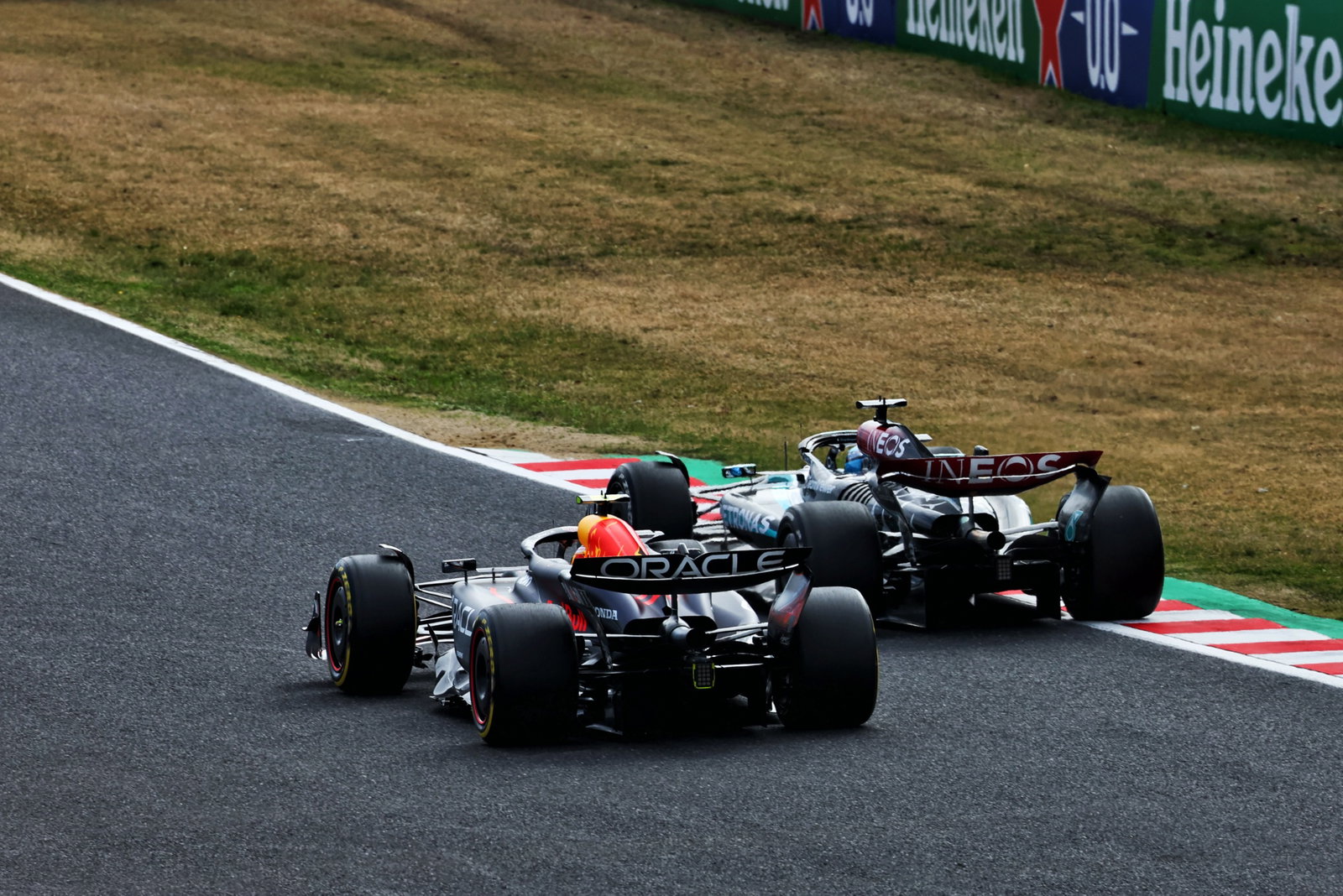 Sergio Perez (MEX) Red Bull Racing RB20 and George Russell (GBR) Mercedes AMG F1 W15 battle for position. Formula 1 World