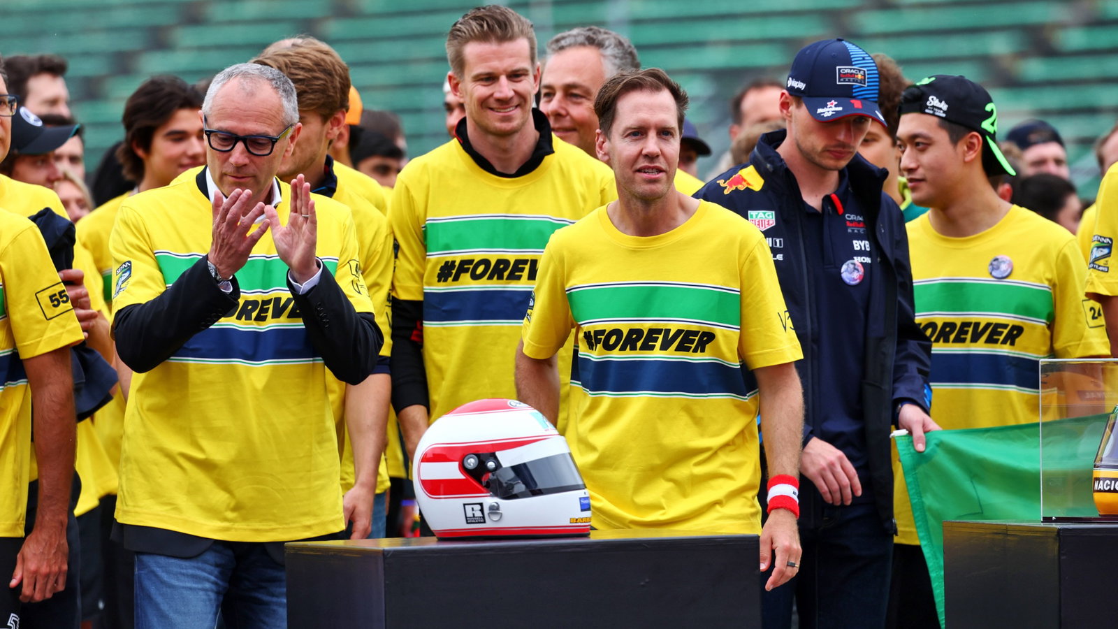 (L to R): Stefano Domenicali (ITA) Formula One President and CEO; Sebastian Vettel (GER) - Drivers and team personnel -