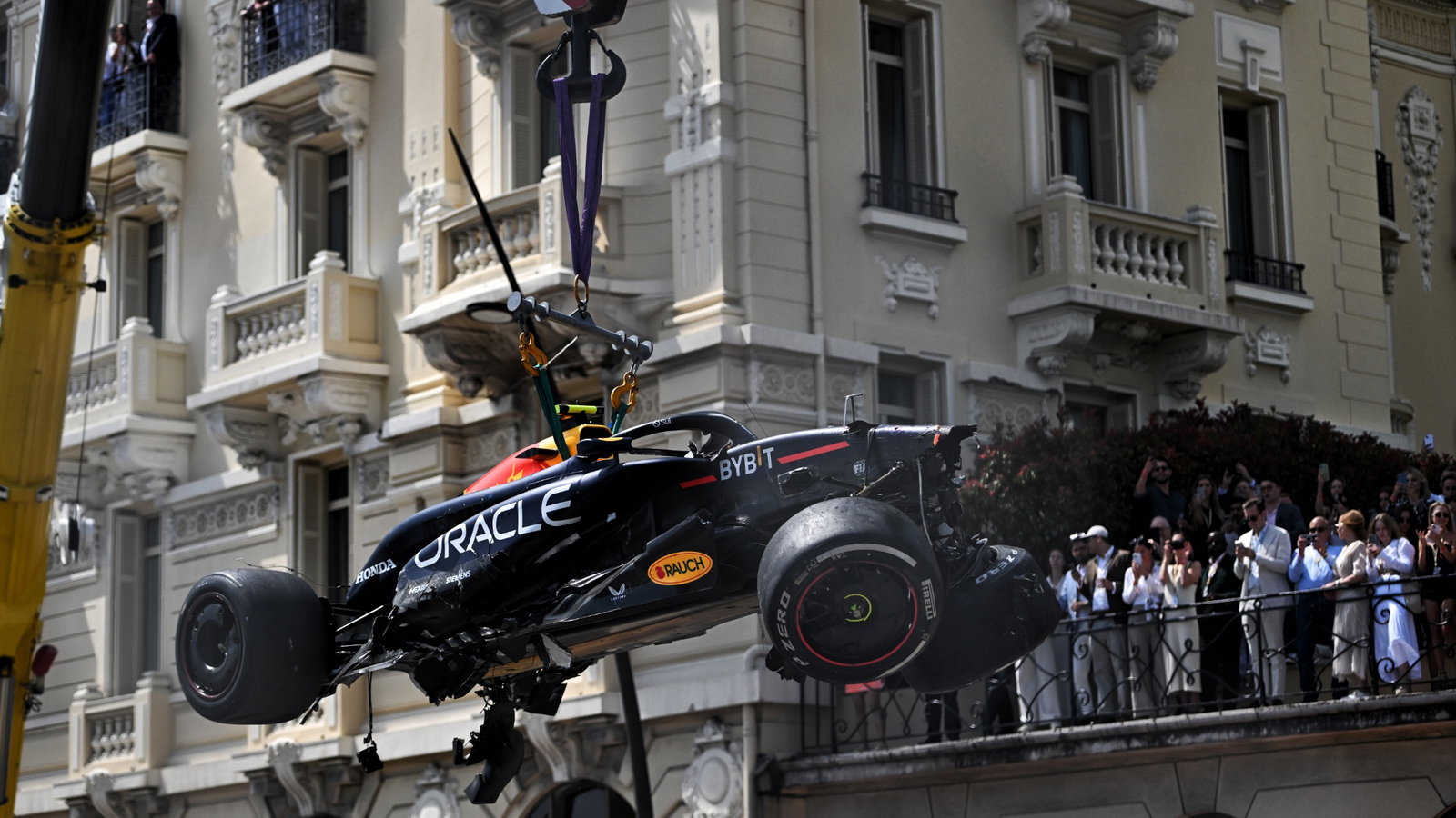 The Red Bull Racing RB20 of Sergio Perez (MEX) Red Bull Racing is craned from the circuit after the race stopping start