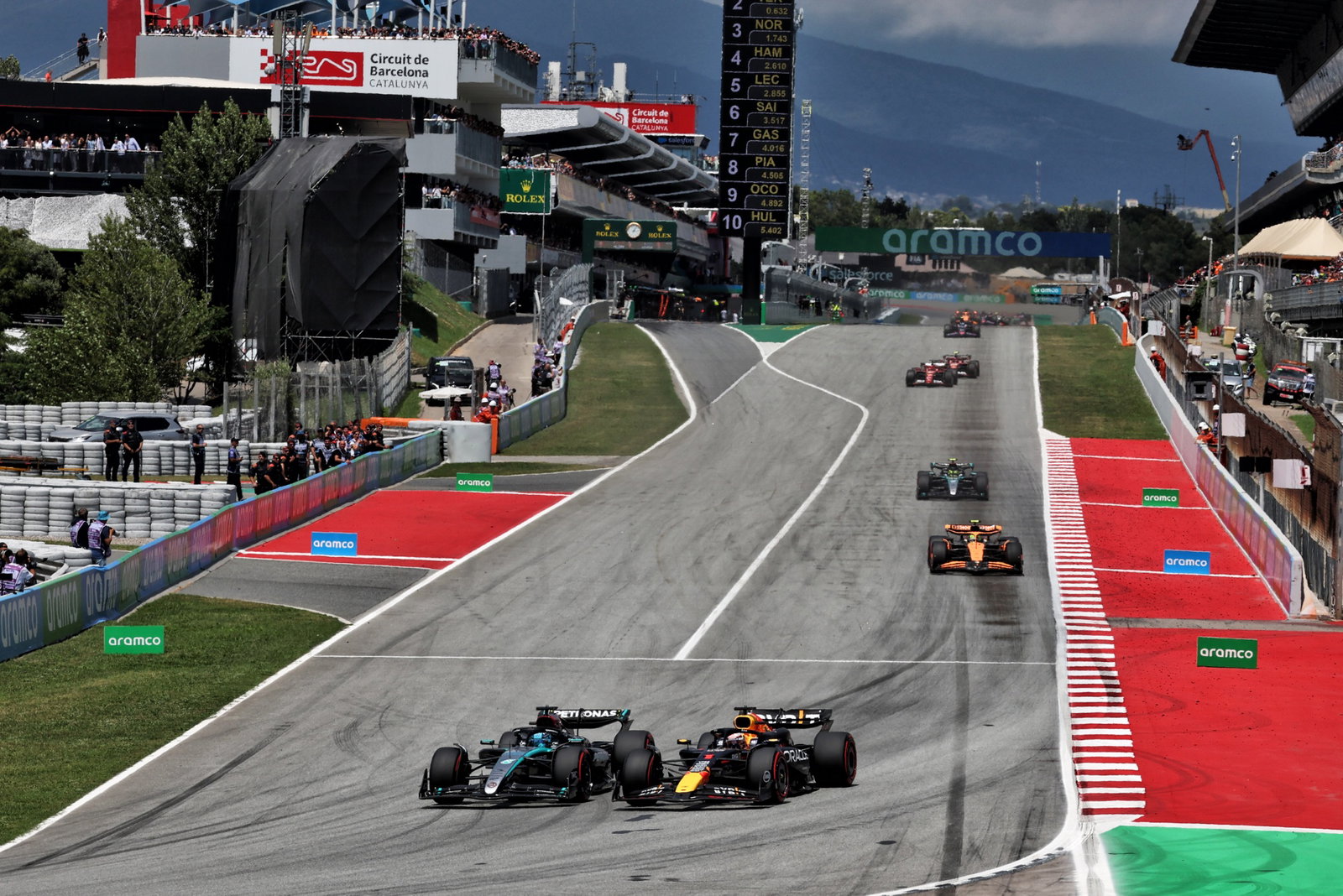 George Russell (GBR) Mercedes AMG F1 W15 loses the lead to Max Verstappen (NLD) Red Bull Racing RB20. Formula 1 World